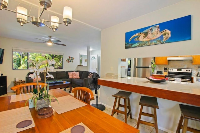 dining space with light tile patterned floors and ceiling fan with notable chandelier