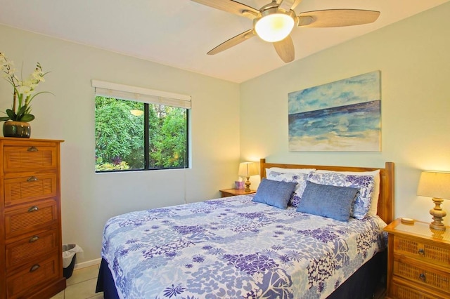 tiled bedroom featuring ceiling fan