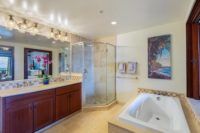 bathroom featuring vanity and independent shower and bath