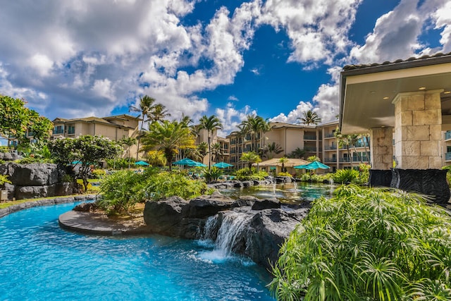 view of swimming pool featuring pool water feature