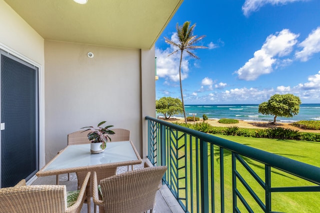 balcony featuring a water view and a view of the beach