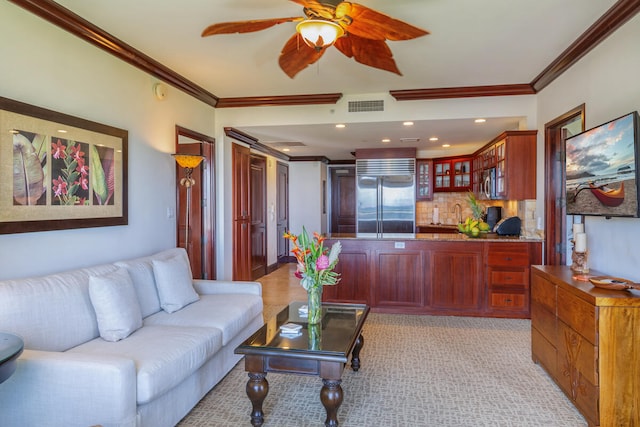 living room with crown molding and ceiling fan