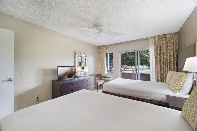 bedroom featuring a textured ceiling, multiple windows, access to outside, and ceiling fan