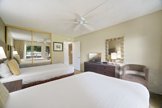 bedroom with a closet, ceiling fan, and a textured ceiling