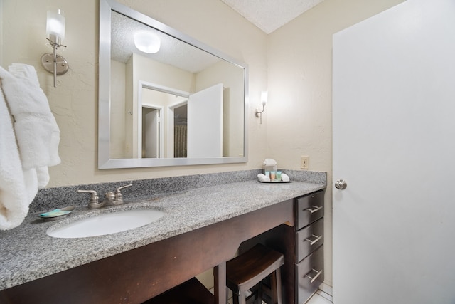 bathroom with vanity and a textured ceiling