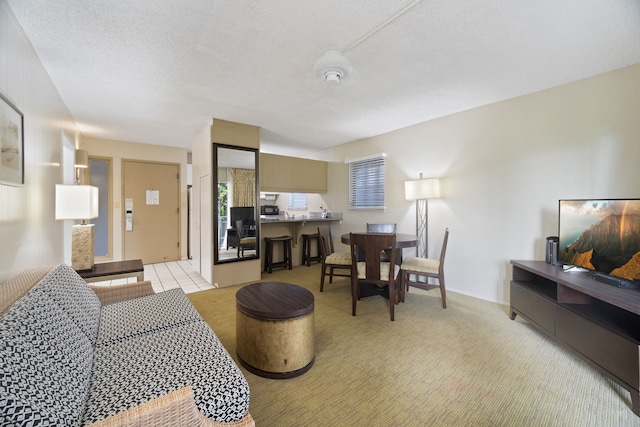 carpeted living room featuring a textured ceiling