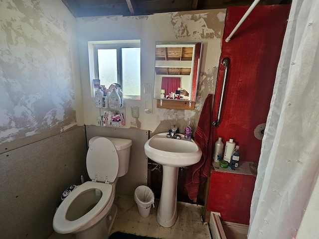 bathroom with toilet and a baseboard radiator