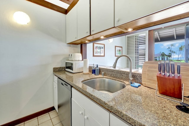 kitchen with light stone countertops, sink, white cabinetry, light tile patterned floors, and dishwasher