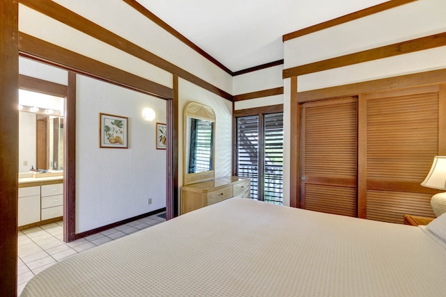 tiled bedroom featuring a closet, crown molding, and connected bathroom