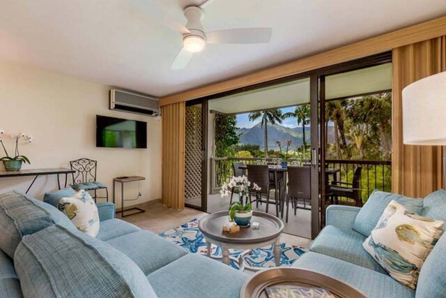 living room with an AC wall unit and ceiling fan