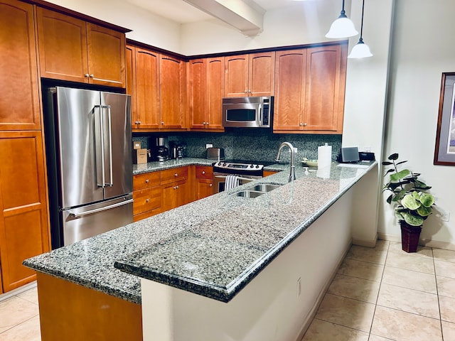 kitchen with stone counters, sink, decorative backsplash, kitchen peninsula, and stainless steel appliances