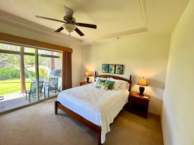 carpeted bedroom featuring ceiling fan, access to outside, and a tray ceiling