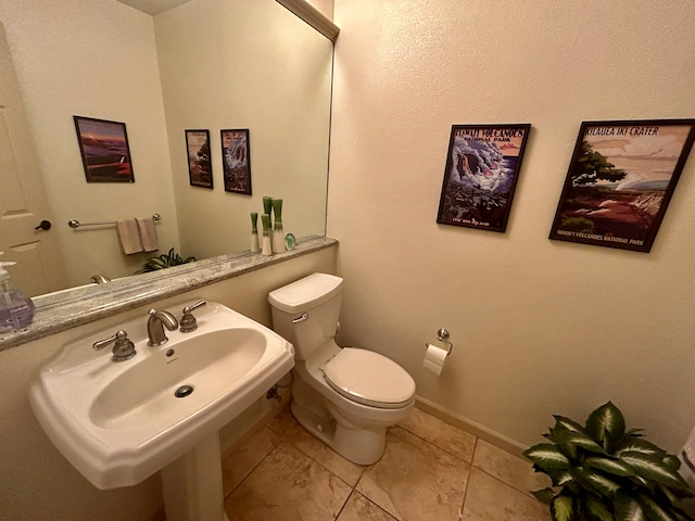 bathroom featuring tile patterned floors, toilet, and sink