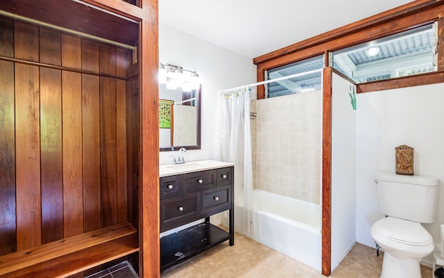 full bathroom featuring shower / bath combination with curtain, vanity, tile patterned flooring, and toilet