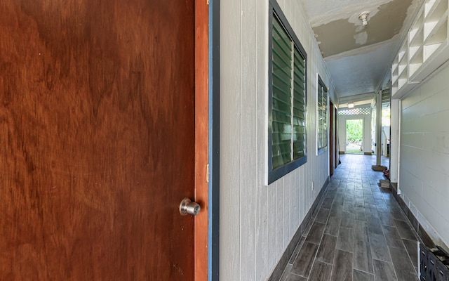 interior space featuring wood walls and dark hardwood / wood-style floors