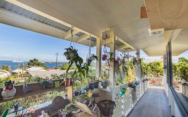 view of patio with a water view and a balcony