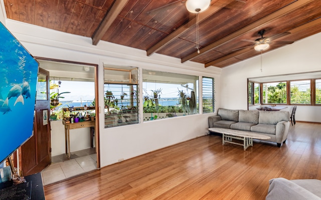 sunroom / solarium with ceiling fan, wood ceiling, and lofted ceiling with beams