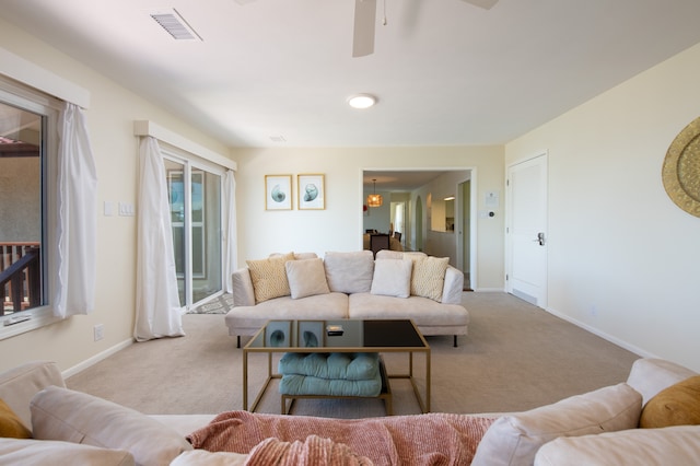 carpeted living room featuring ceiling fan