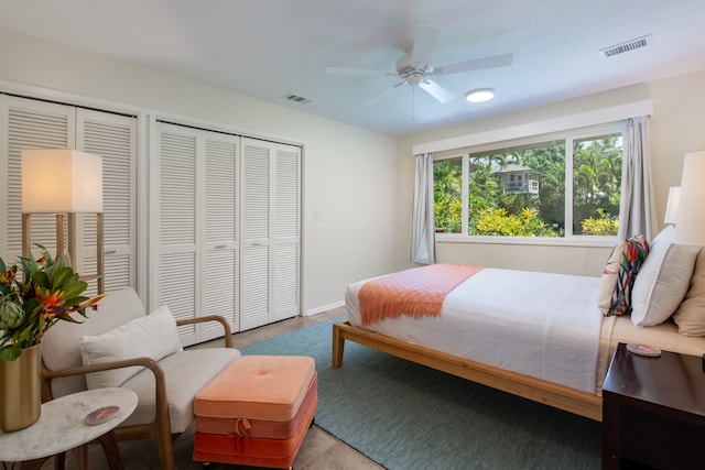 bedroom with two closets and ceiling fan