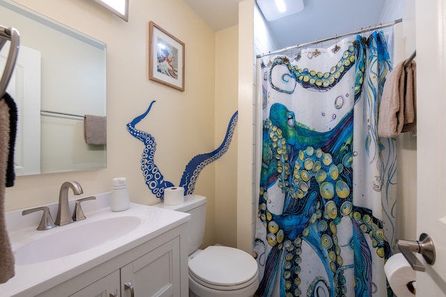 bathroom featuring vanity, a shower with shower curtain, and toilet