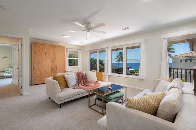 living room with light carpet and ceiling fan