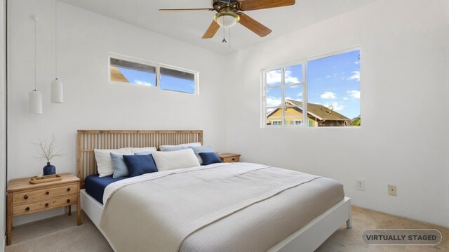 bedroom featuring ceiling fan and light colored carpet