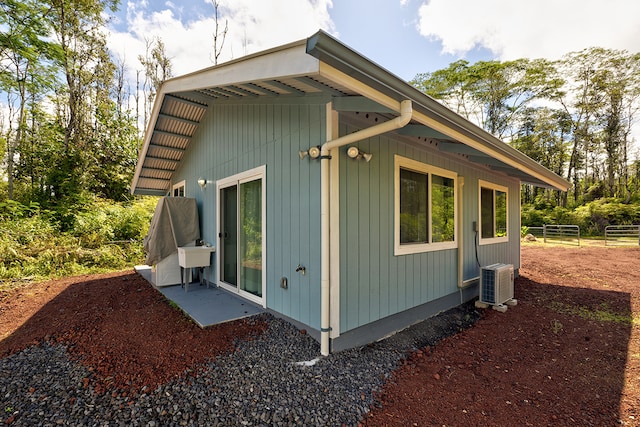 view of side of property featuring sink and a patio