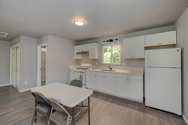 kitchen featuring sink, white cabinets, white appliances, and light hardwood / wood-style floors