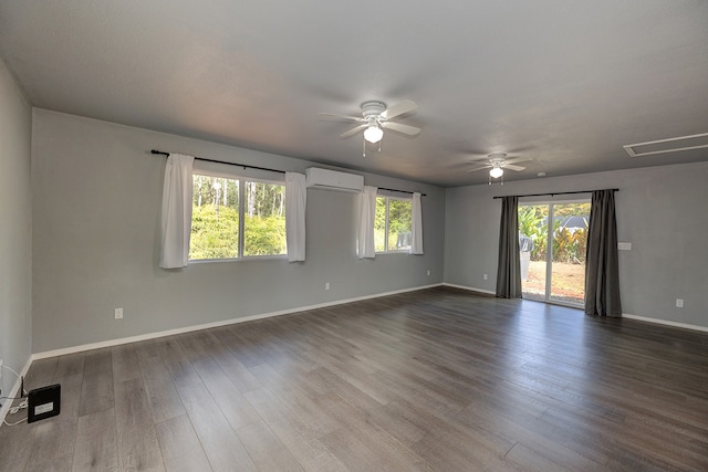 unfurnished room with a wall mounted air conditioner, dark wood-type flooring, and ceiling fan