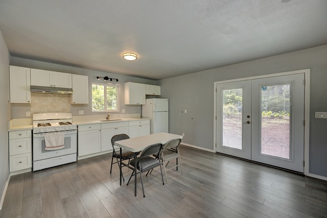 kitchen with french doors, light hardwood / wood-style floors, white appliances, and plenty of natural light