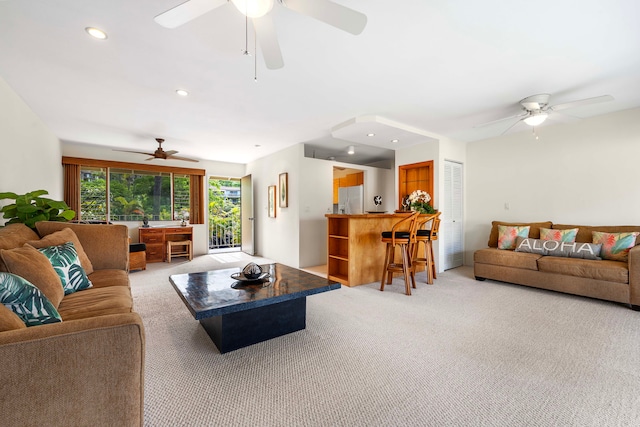 living room with ceiling fan and light colored carpet