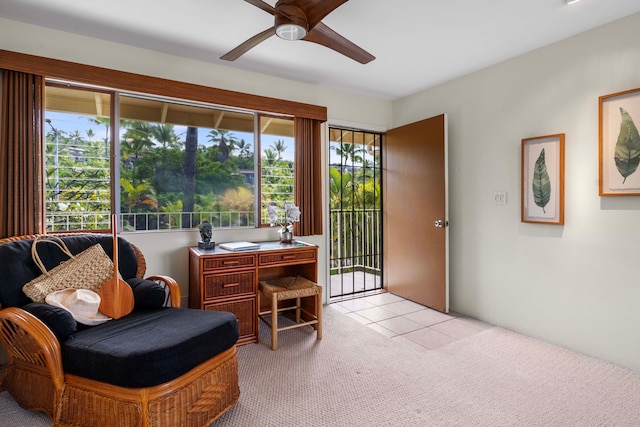 sitting room with ceiling fan, plenty of natural light, and light colored carpet