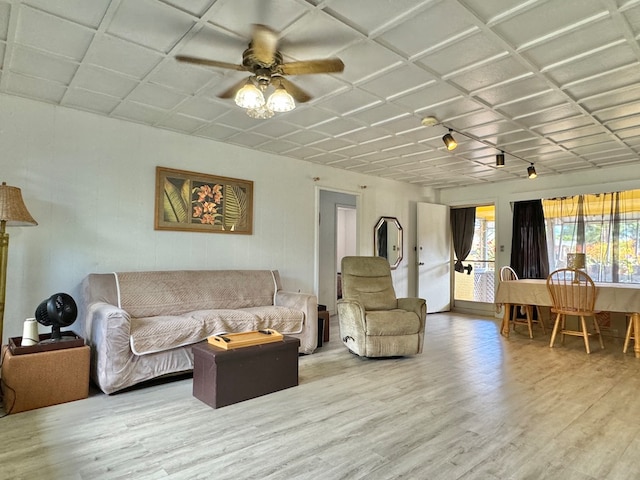 living room featuring wood-type flooring and ceiling fan