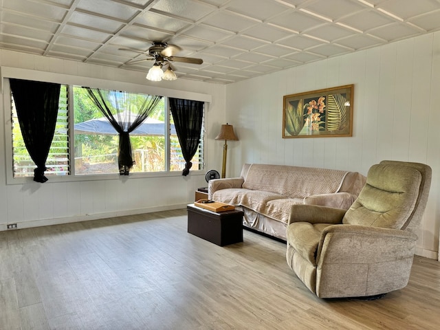 living room with light hardwood / wood-style floors and ceiling fan