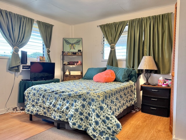 bedroom featuring light wood-type flooring and multiple windows