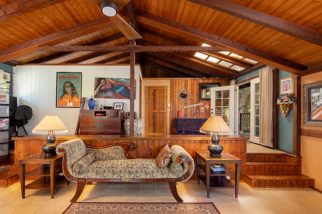 sitting room with wood walls, vaulted ceiling with beams, and light tile patterned flooring