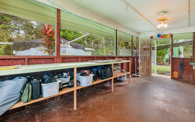 sunroom / solarium featuring ceiling fan