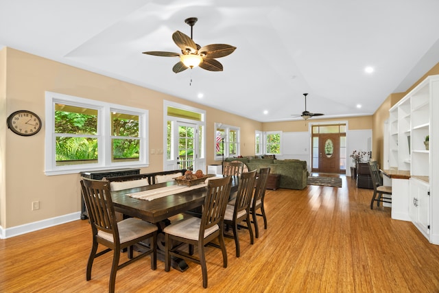 dining area with ceiling fan, light hardwood / wood-style flooring, and lofted ceiling