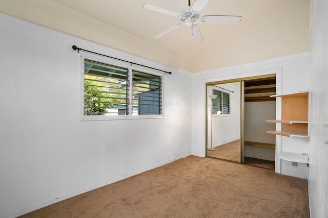 unfurnished bedroom featuring ceiling fan, a closet, and light colored carpet