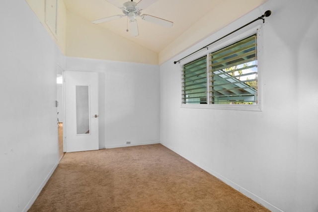 carpeted empty room with vaulted ceiling and ceiling fan