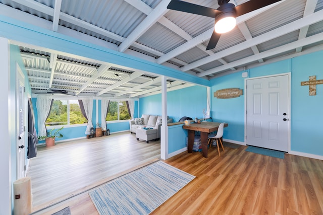 entryway with wood-type flooring, beam ceiling, and ceiling fan