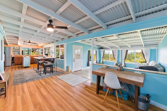 home office with beam ceiling, ceiling fan, and light hardwood / wood-style flooring