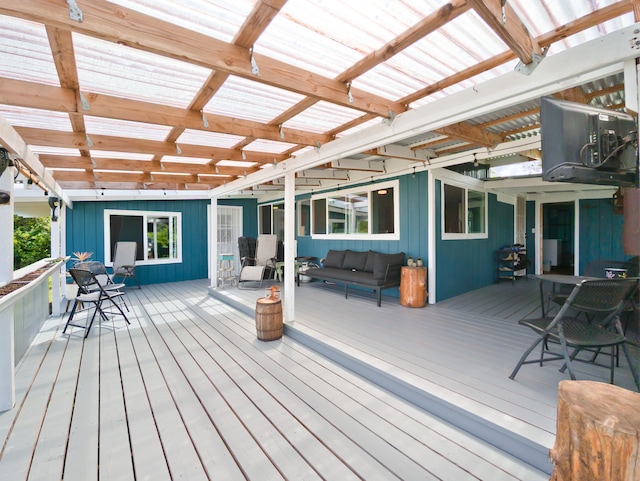 wooden terrace with an outdoor living space