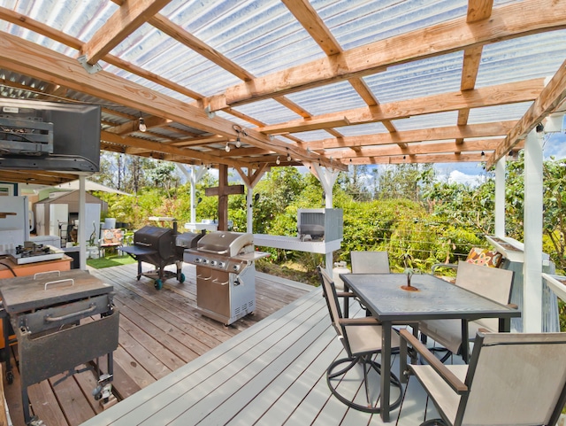 deck with area for grilling and a pergola