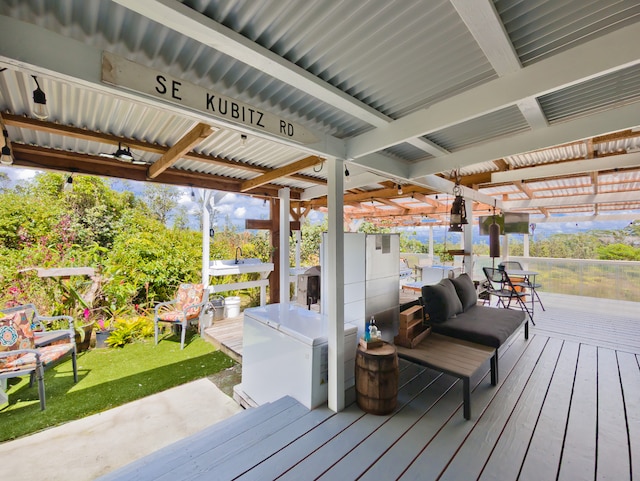 wooden terrace with a lawn