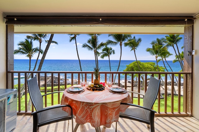 balcony featuring a water view and a beach view