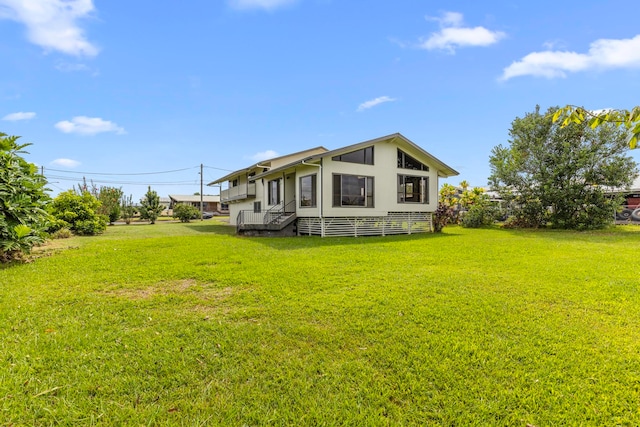 back of house with a yard and a wooden deck