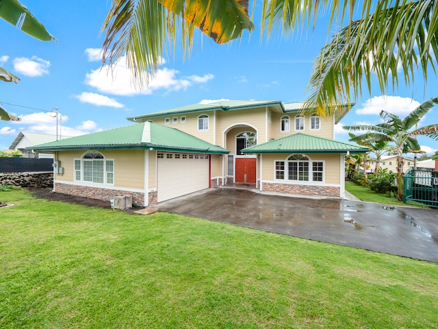 view of front of home with a front lawn and a garage