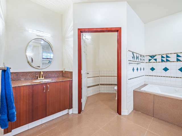 bathroom with vanity, toilet, tile patterned flooring, and a bathing tub