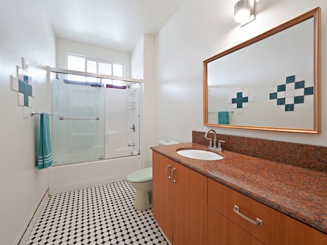 full bathroom featuring toilet, enclosed tub / shower combo, and vanity